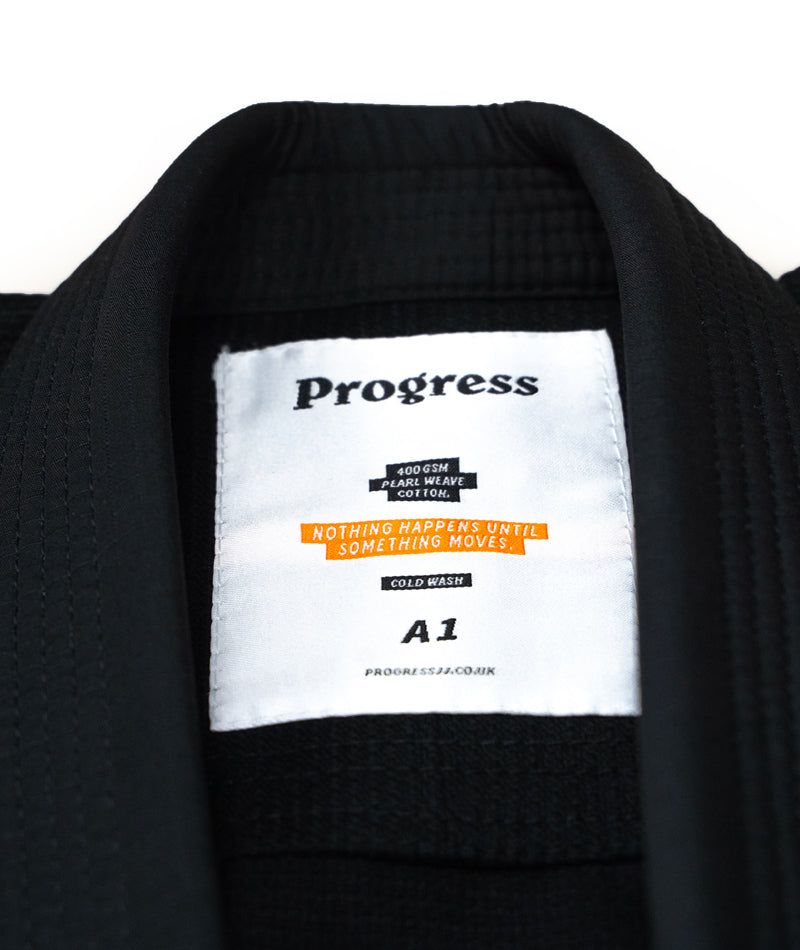 A close up image of the black Featherlight Lightweight Competition Kimono tag containing the brand name and size.